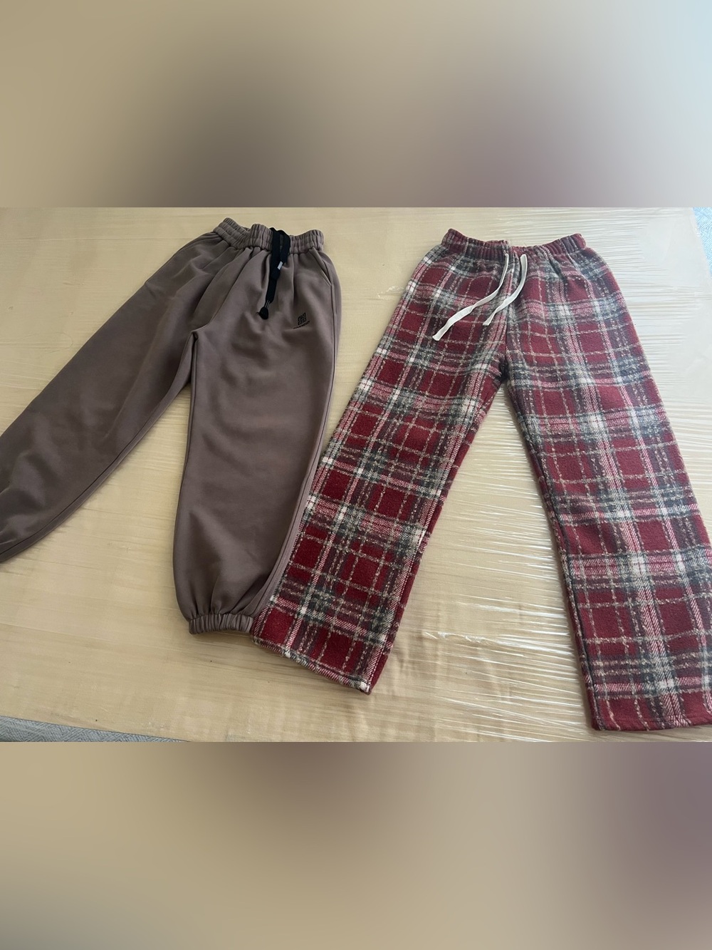 two pairs of casual lounge pants: one in a solid taupe or brown sweatpant style